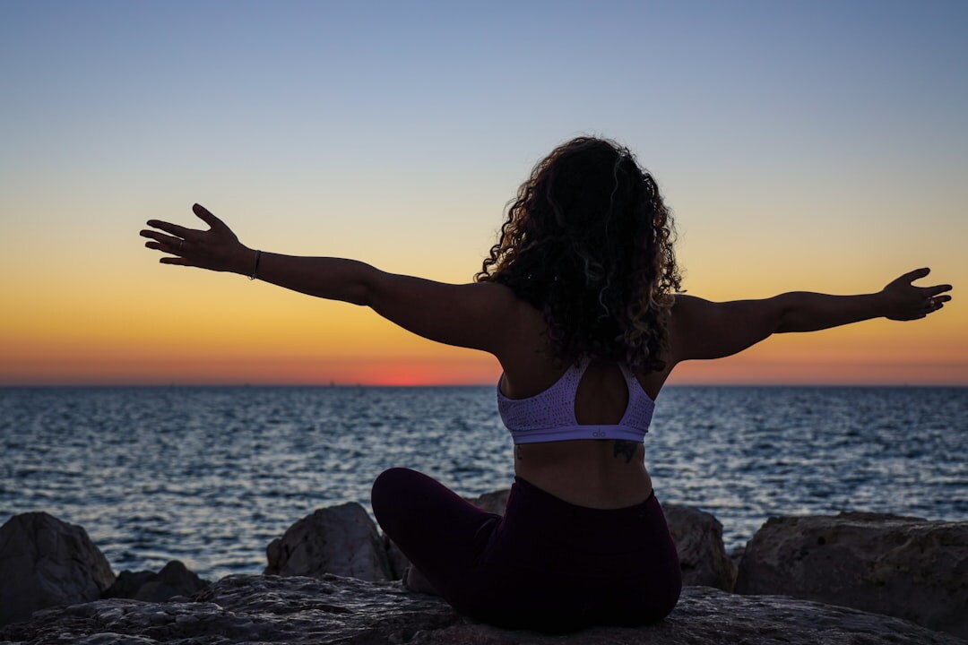 woman meditating at sunrise