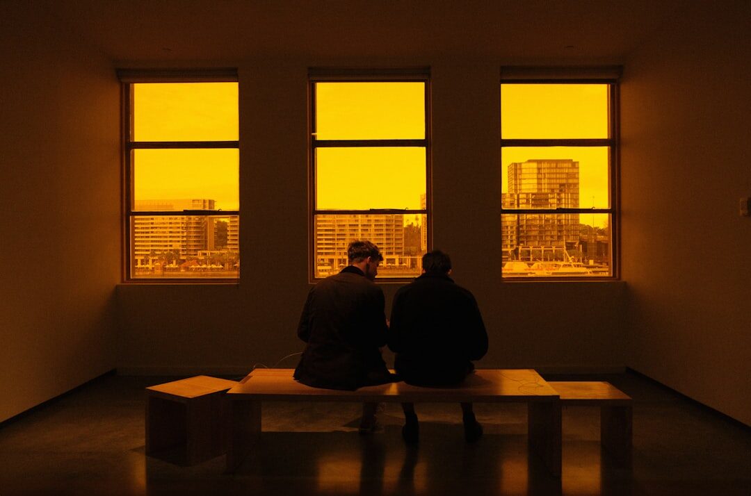person reading book by window